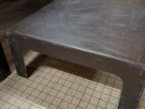 a coffee table that is sitting on a tiled floor
