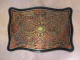 an image of a decorative tray with a gold and red design