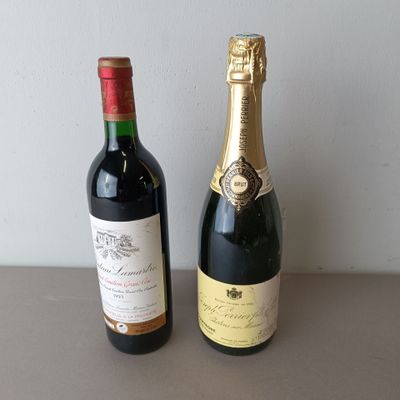 two bottles of wine sitting next to each other on a table