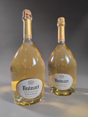 two bottles of wine sitting next to each other on top of a table