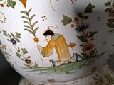a vase with a picture of a man and a dog on it