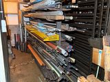 many skis and ski poles stacked up in a garage
