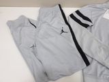 a close up of a pair of pants and a jacket on a table