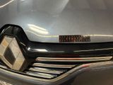 a close up of a car ' s front grill with a number plate on it