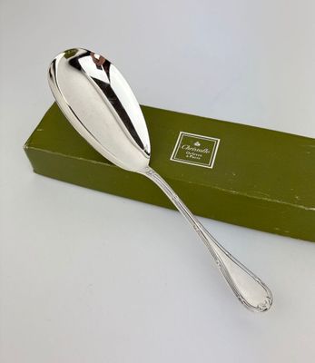 a silver spoon sitting on top of a green box
