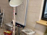 a lamp that is sitting on a table in the corner of a room