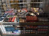 a metal cart filled with books and magazines in a store