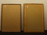 pair of wooden framed mirrors on a wall in an empty room