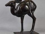 an image of a bronze statue of a ram standing on a base