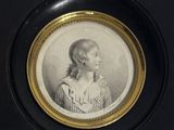 portrait of a woman in a striped dress in a black frame