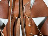 a close up of a bag with leather straps on it
