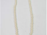 a white pearl necklace with a silver clasp on a white background