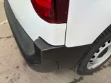a close up of a white truck with a red tail light