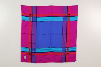 pink and blue plaid scarf hanging on a white wall
