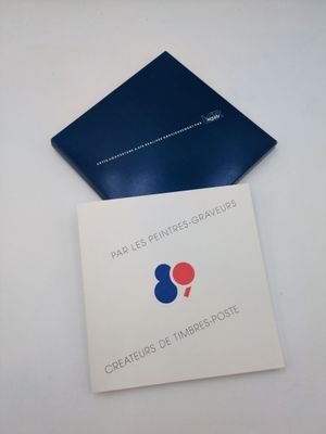a close up of a book on a white surface with a blue cover