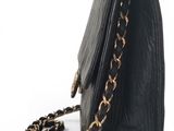 a black purse with a chain hanging from it ' s side