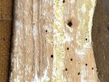 a close up of a wooden cutting board with a knife on it