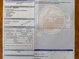 a close up of a receipt on a table next to a car