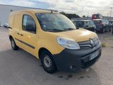 yellow van parked in a parking lot with other cars in the background