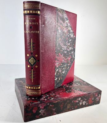 an old book is sitting on top of a book stand