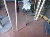 a vacuum cleaner that is on the floor in front of a glass door