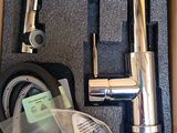 a box with a faucet and a hose in it