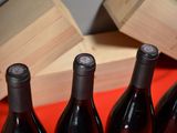 several bottles of wine are lined up on a red table