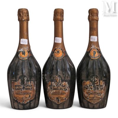 three bottles of champagne sitting next to each other on a white surface
