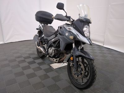 a motorcycle that is parked on a checkered floor
