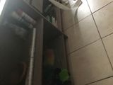 a toilet paper roll hanging from a cabinet in a bathroom