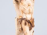 an ivory figurine of a man holding a sword