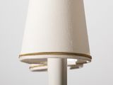 a lamp that has a white shade on it
