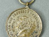 a close up of a medal on a white surface