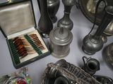 many silver objects on a table with a silver tray