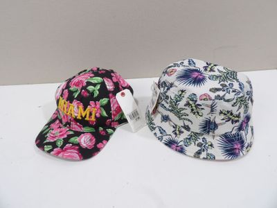 two hats are sitting on a table with a tag on it