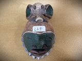 a mask on the wall with a price tag on it
