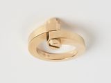 gros plan d'une bague en or sur une surface blanche