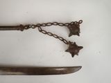 a knife with a chain attached to it and a star on it
