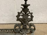 an old iron fire hydrant sitting on the sidewalk