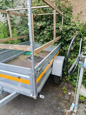 a trailer that has a cage on the back of it