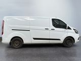 the white van is parked in a parking lot on a cloudy day