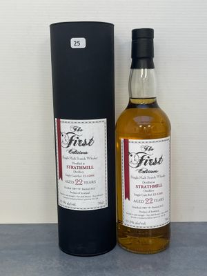 une photo d'une bouteille de whisky posée à côté d'une boîte noire