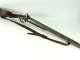 an old gun with a wooden handle on a white surface