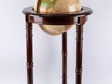 a small wooden table with a globe on top of it