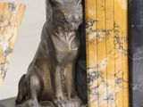 a bookend with a cat sitting on top of it