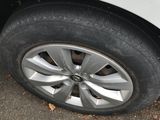the tire of a white car with a flat tire on the ground