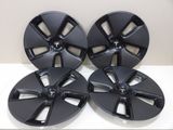 a set of four black wheel rims for a car