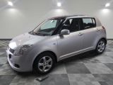 a picture of a silver suzuki minivan parked in a garage