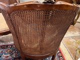 a chair that is sitting on a rug in a room