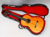 a guitar in a case on a white surface
